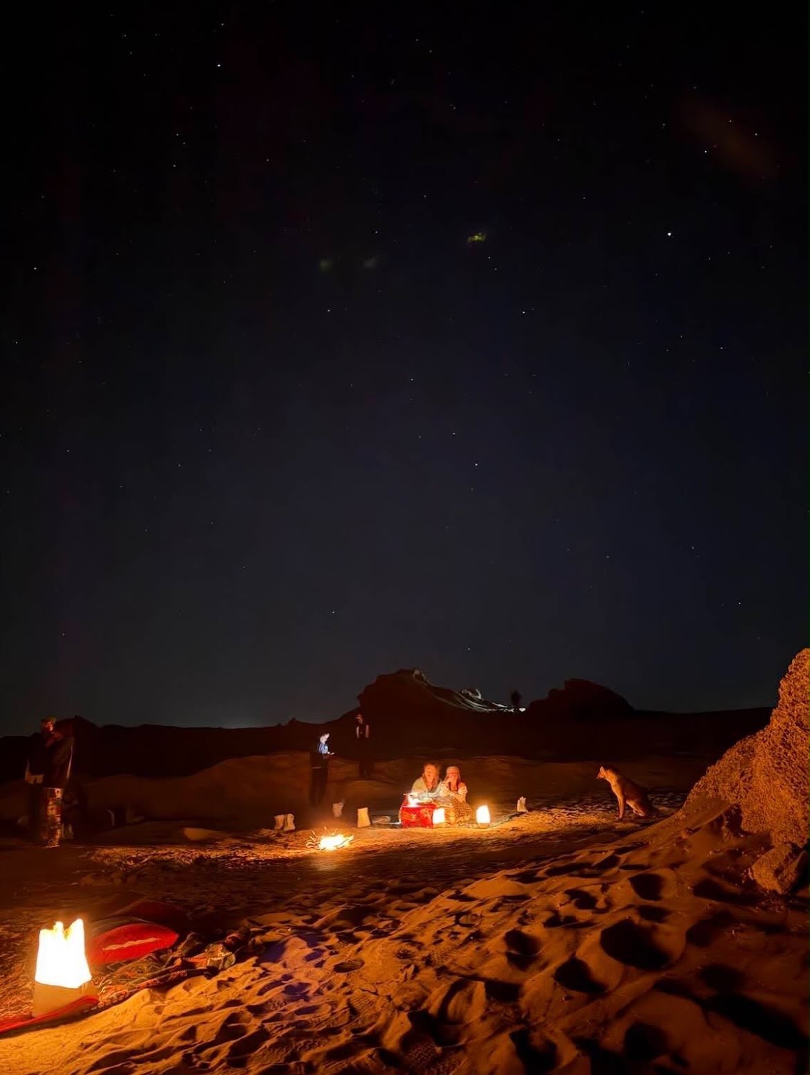 Candles and stars on the dunes at night